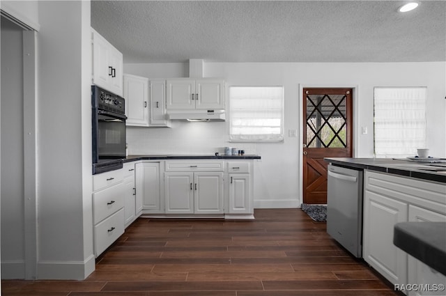 kitchen featuring black oven, tasteful backsplash, stainless steel dishwasher, dark wood-type flooring, and white cabinetry