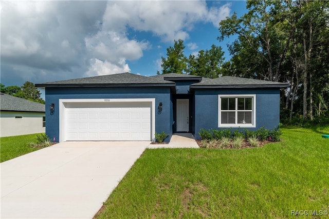 view of front of house with a front lawn and a garage