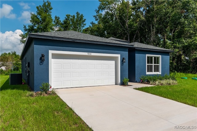 ranch-style house with cooling unit, a front yard, and a garage