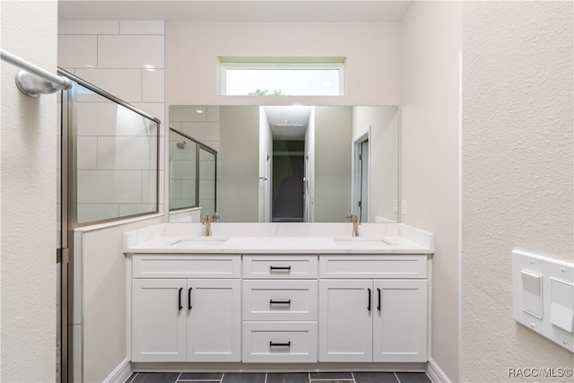 bathroom featuring vanity and a shower with door