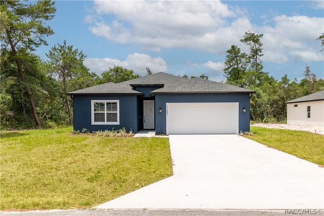 view of front of property featuring a garage and a front lawn