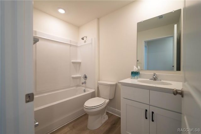 full bathroom featuring hardwood / wood-style floors, vanity, toilet, and shower / bath combination