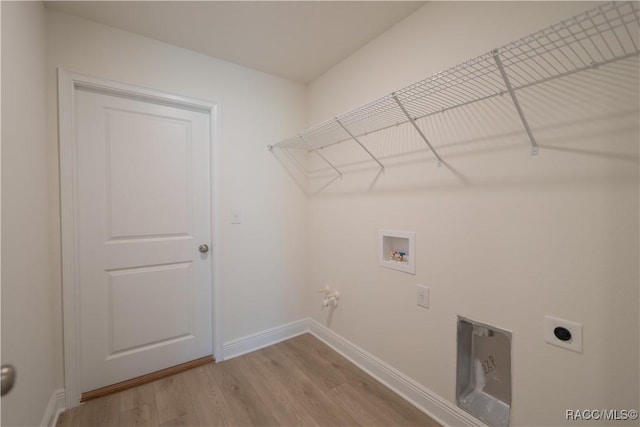 clothes washing area featuring hookup for a gas dryer, hookup for a washing machine, wood-type flooring, and hookup for an electric dryer