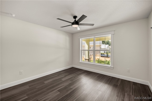 unfurnished room featuring ceiling fan, baseboards, and dark wood-style flooring