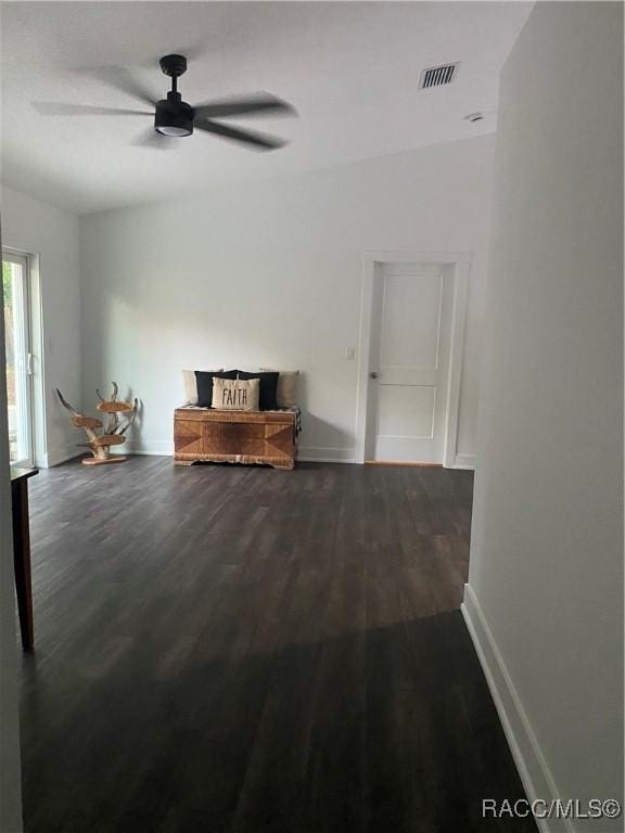 unfurnished living room with ceiling fan and dark hardwood / wood-style flooring