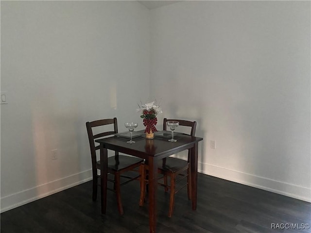 dining space featuring dark hardwood / wood-style floors