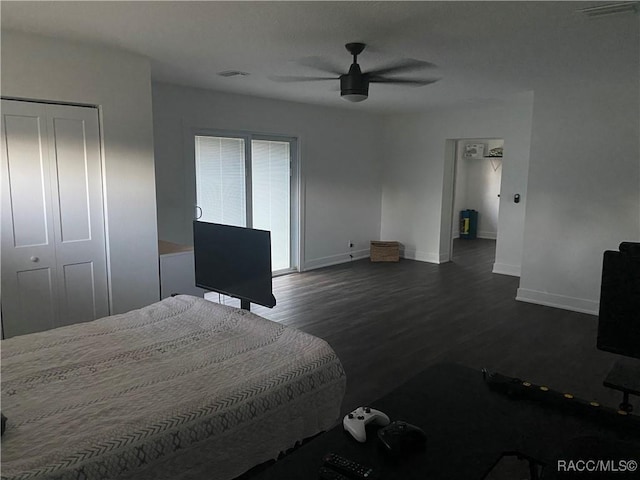 bedroom with ceiling fan, a closet, and dark hardwood / wood-style floors