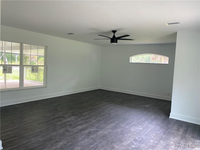 unfurnished room featuring dark hardwood / wood-style floors and ceiling fan