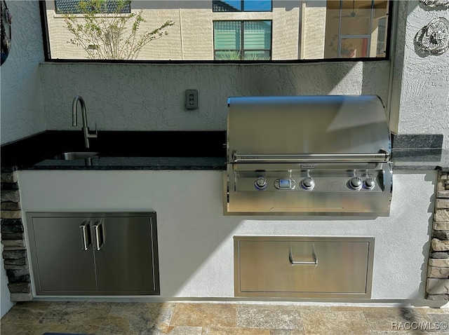 view of patio with a grill and sink