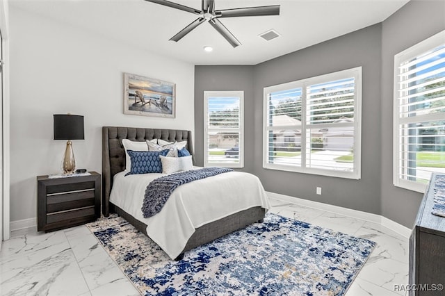 bedroom featuring multiple windows and ceiling fan