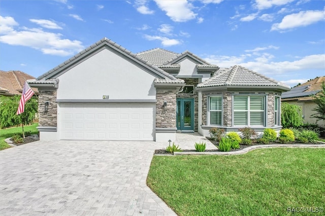 view of front of house featuring a garage and a front lawn