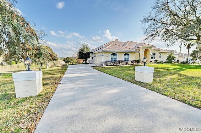 view of front facade with a front lawn and a garage