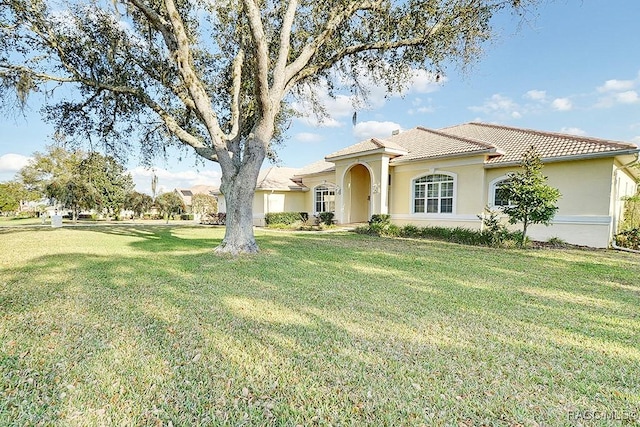 mediterranean / spanish-style home with a front lawn