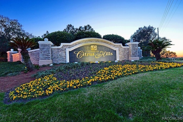 community / neighborhood sign with a lawn