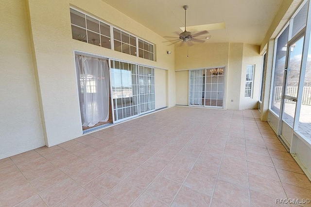 unfurnished sunroom featuring lofted ceiling and ceiling fan