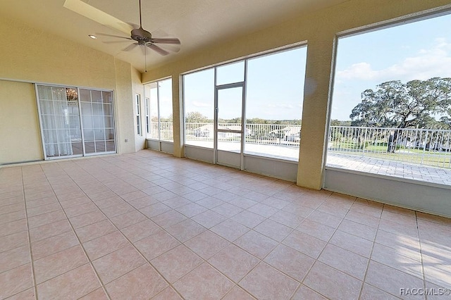 unfurnished sunroom with ceiling fan