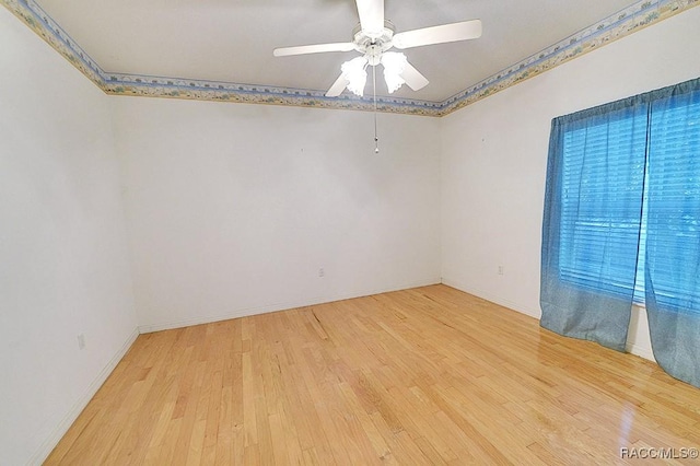 empty room with ceiling fan and light wood-type flooring