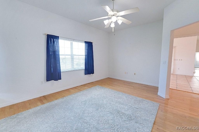 unfurnished room with ceiling fan and light wood-type flooring