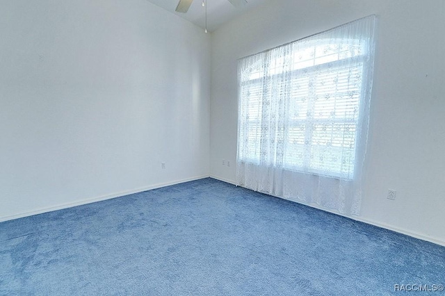 carpeted empty room featuring ceiling fan