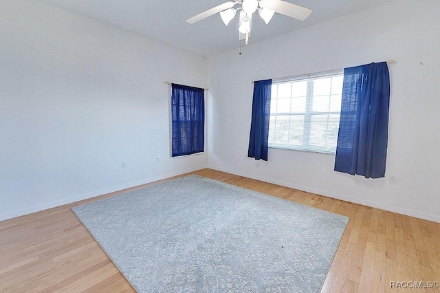 spare room with hardwood / wood-style floors and ceiling fan