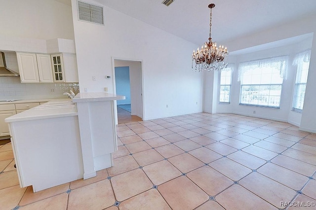 interior space featuring high vaulted ceiling, sink, a chandelier, and light tile patterned floors