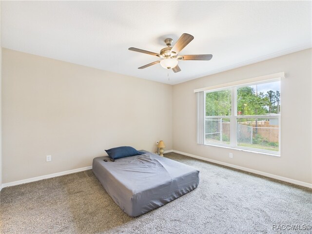 178 W Navarro Pl, Citrus Springs, FL 34434 - carpeted bedroom with baseboards and a ceiling fan