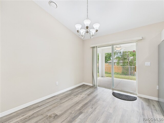 178 W Navarro Pl, Citrus Springs, FL 34434 - empty room featuring wood finished floors, baseboards, a chandelier, and lofted ceiling