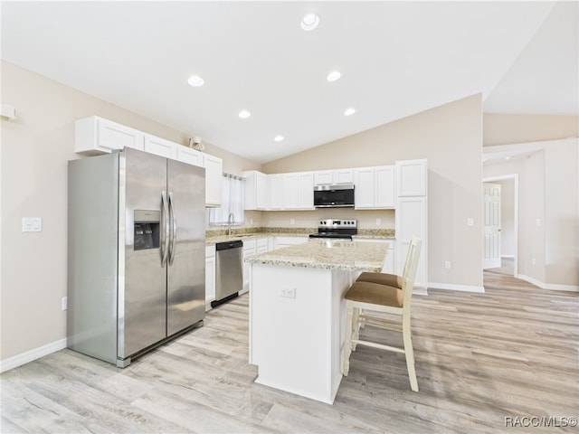 178 W Navarro Pl, Citrus Springs, FL 34434 - kitchen featuring appliances with stainless steel finishes, a kitchen island, a sink, light wood finished floors, and lofted ceiling
