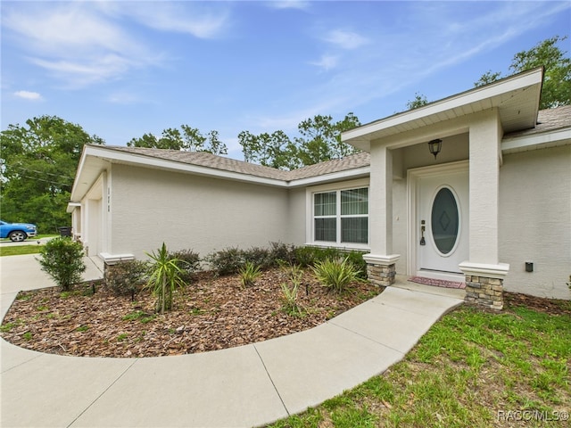 178 W Navarro Pl, Citrus Springs, FL 34434 - property entrance with stucco siding and driveway