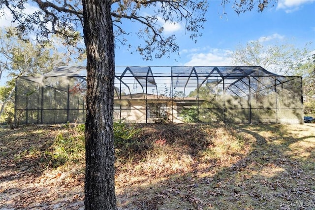 view of yard with glass enclosure