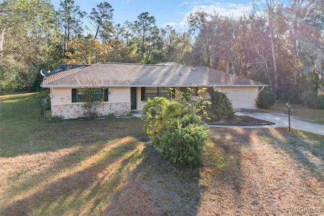 ranch-style home featuring a front yard and a garage