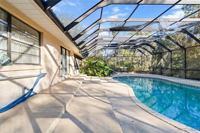 view of swimming pool with a lanai and a patio area