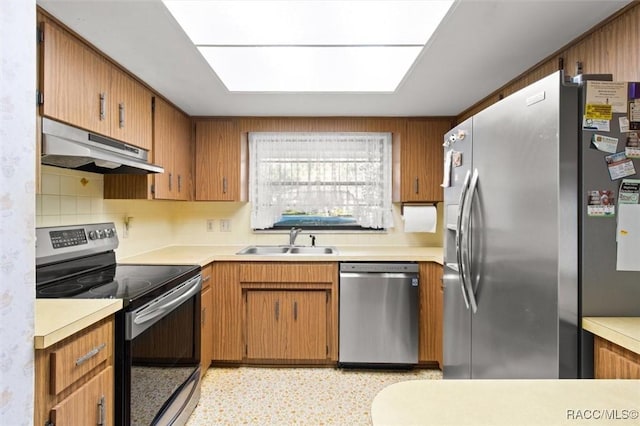 kitchen featuring decorative backsplash, sink, and appliances with stainless steel finishes