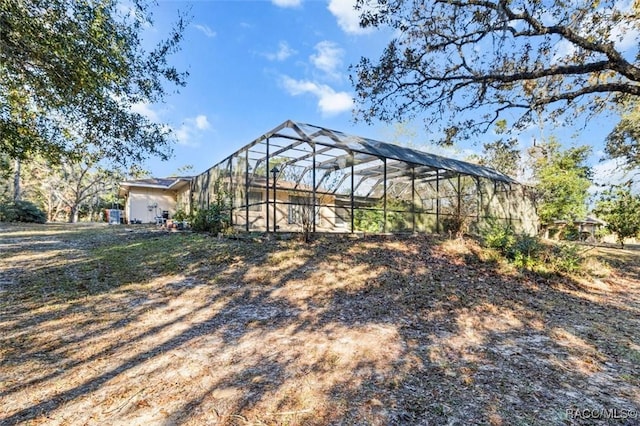 view of yard with glass enclosure