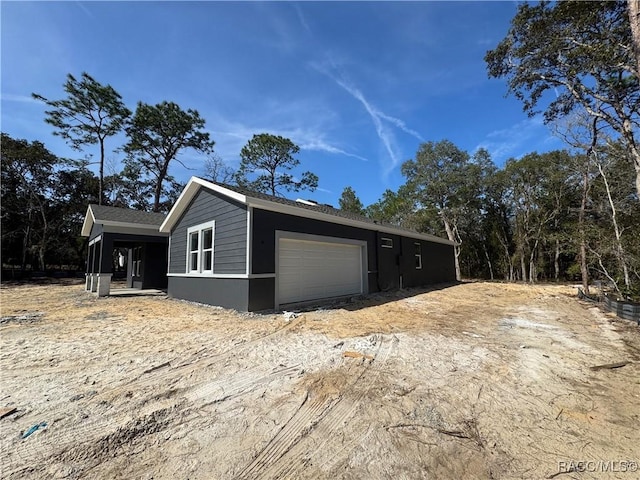 view of property exterior with an attached garage