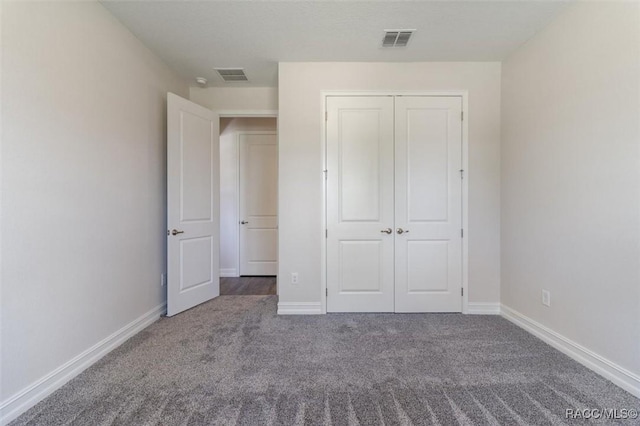 unfurnished bedroom with carpet and a closet