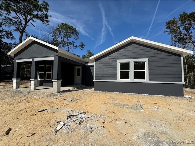 back of property featuring a patio