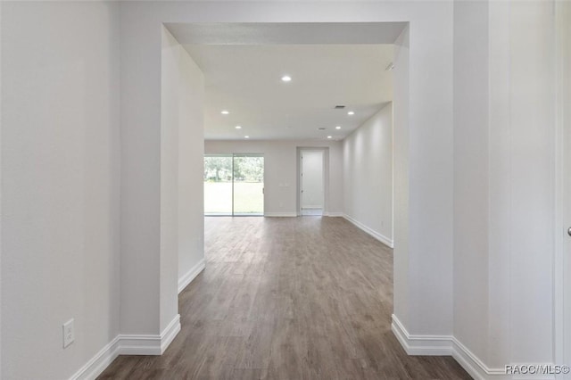 corridor with hardwood / wood-style floors