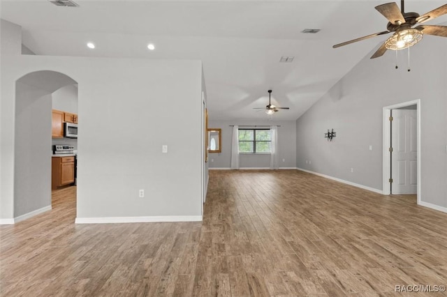 17 Eugenia Ct, Homosassa, FL 34446 - unfurnished living room featuring arched walkways, light wood-type flooring, a ceiling fan, visible vents, and baseboards