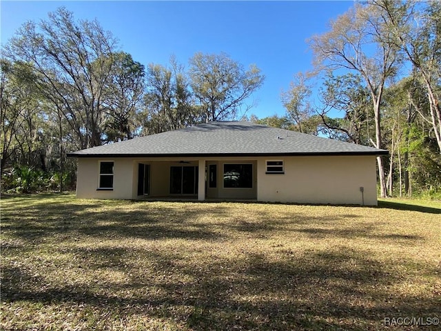 rear view of house with a lawn