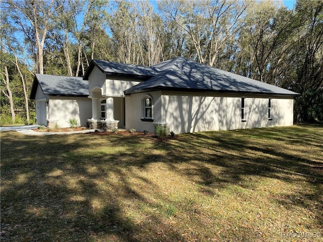 view of side of home with a yard