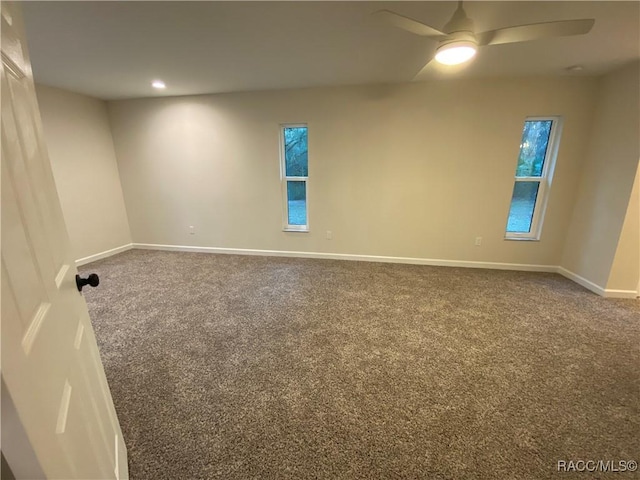 carpeted empty room featuring ceiling fan