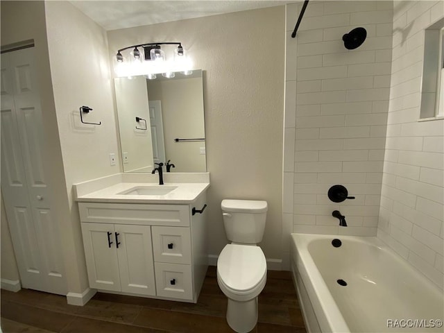 full bathroom with toilet, hardwood / wood-style floors, vanity, and tiled shower / bath