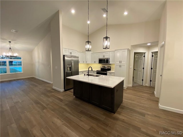 kitchen with a kitchen island with sink, sink, stainless steel appliances, and dark hardwood / wood-style floors