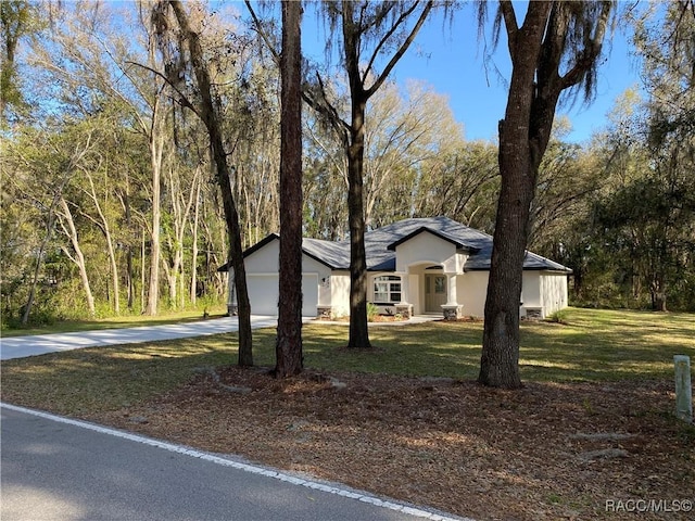 view of front of property featuring a garage and a front lawn