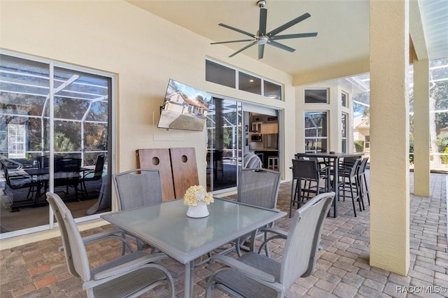 view of patio with ceiling fan and a lanai