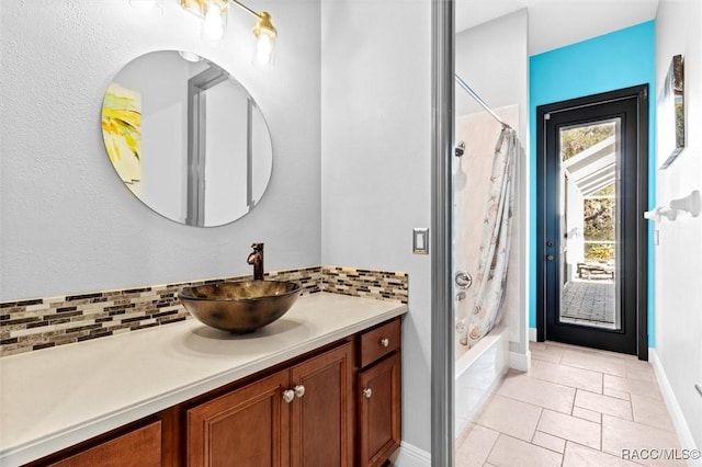 bathroom with tasteful backsplash, vanity, tile patterned floors, and shower / bathtub combination with curtain