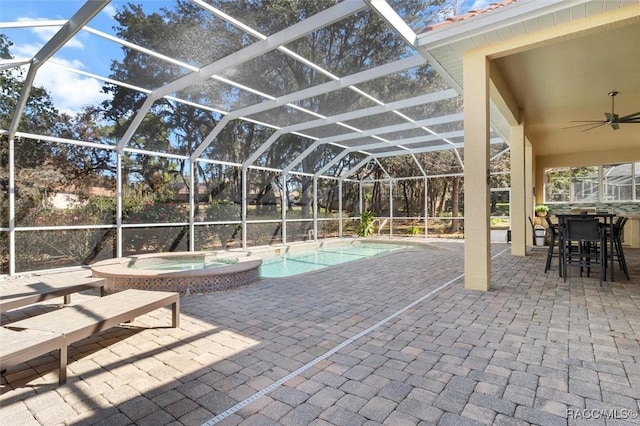 view of swimming pool featuring an in ground hot tub, ceiling fan, a patio, and glass enclosure