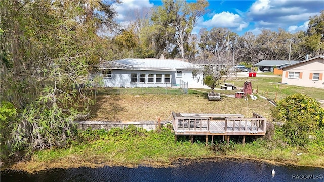 rear view of property with a deck with water view