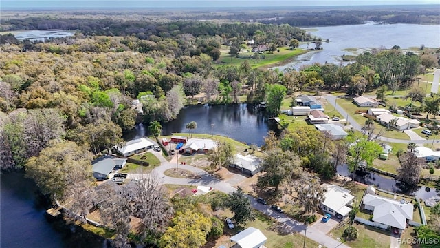 aerial view featuring a water view, a wooded view, and a residential view